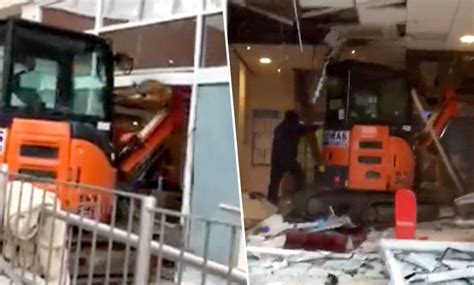 guy destroys building with mini excavator|Disgruntled Unpaid Worker Destroys New Travelodge Hotel.